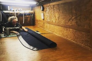 Mark-Minor-working-on-marine-canvas-in-mobile-workshop